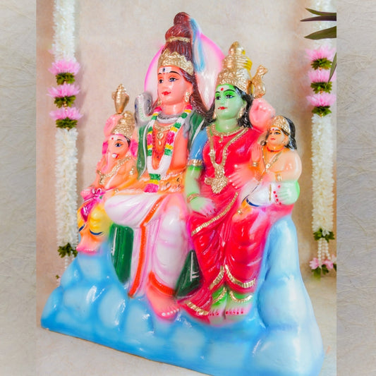 Handcrafted Navarathri Golu doll set depicting the Shiva family, vibrantly painted and adorned with floral decorations.