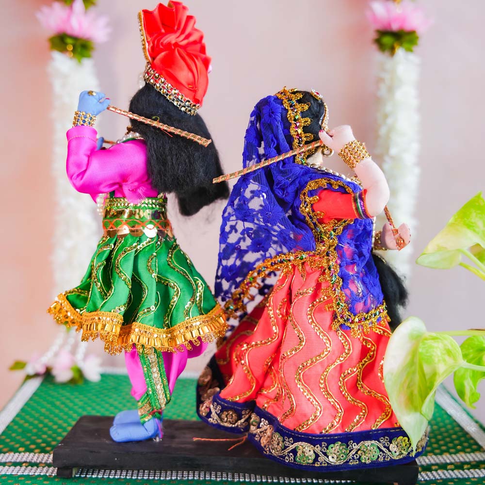 Handcrafted Radha Krishna dolls performing Dandiya dance, dressed in vibrant traditional attire with detailed embellishments and Dandiya sticks.