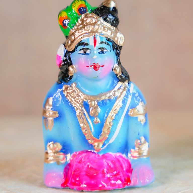 Handcrafted Navarathri Golu doll - Baby Krishna crawling with intricate jewelry and vibrant colors.