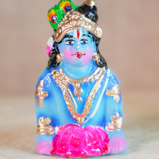 Handcrafted Navarathri Golu doll - Baby Krishna crawling with intricate jewelry and vibrant colors.