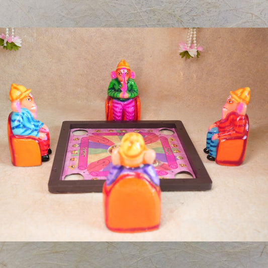 Handcrafted Navarathri Golu doll set of four Ganeshas seated around a carrom board, engaging in a game.