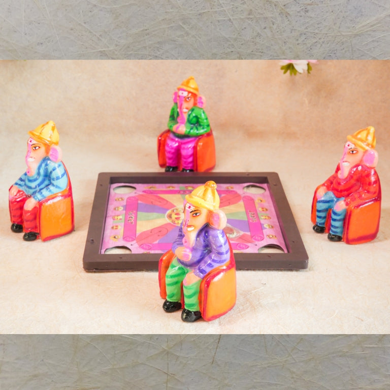 Handcrafted Navarathri Golu doll set of four Ganeshas seated around a carrom board, engaging in a game.