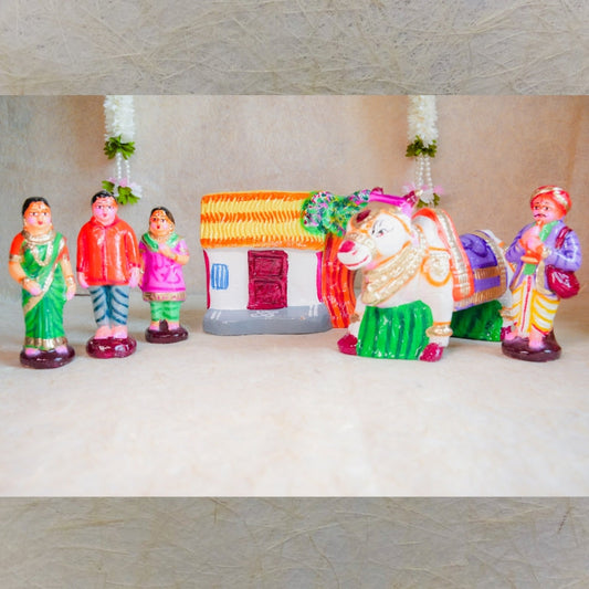 Handcrafted Navarathri Golu doll set featuring a decorated bull, a rural family, a house, and a storyteller.