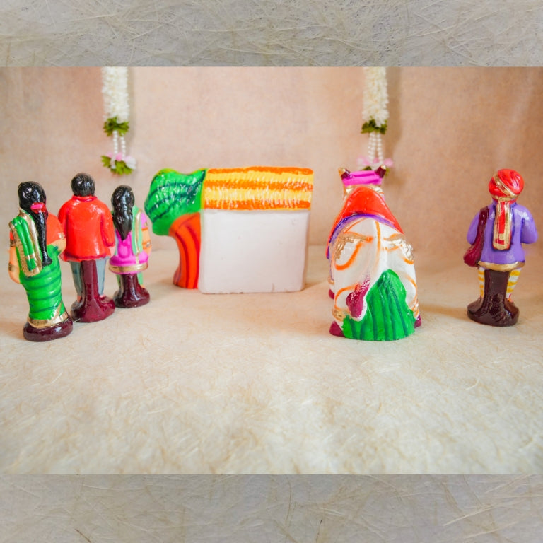Handcrafted Navarathri Golu doll set featuring a decorated bull, a rural family, a house, and a storyteller.