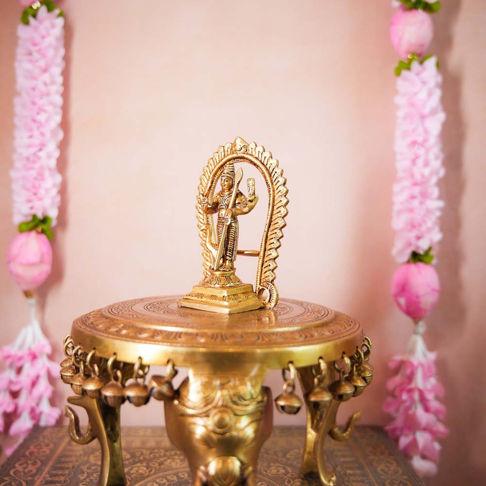 Handcrafted Brass Murugan Idol with an ornate arch, intricately detailed, ideal for home temples and festive decor.