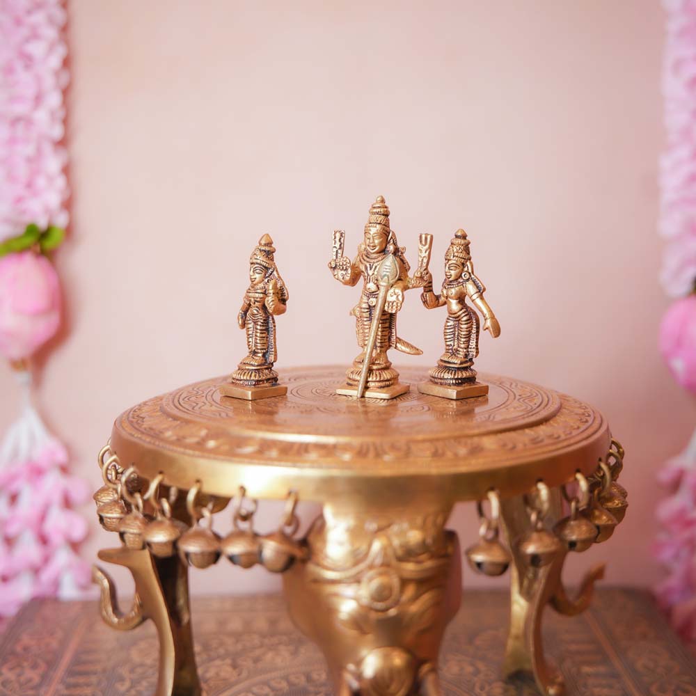 Handcrafted Brass Murugan Set featuring Lord Murugan with Valli and Devasena, intricately detailed and perfect for home temples and Navaratri displays.