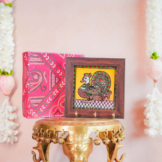 Decorative keyholder featuring a hand-painted Annam (mythical swan) design on a vibrant yellow background, framed with dark wood, and equipped with key hooks.