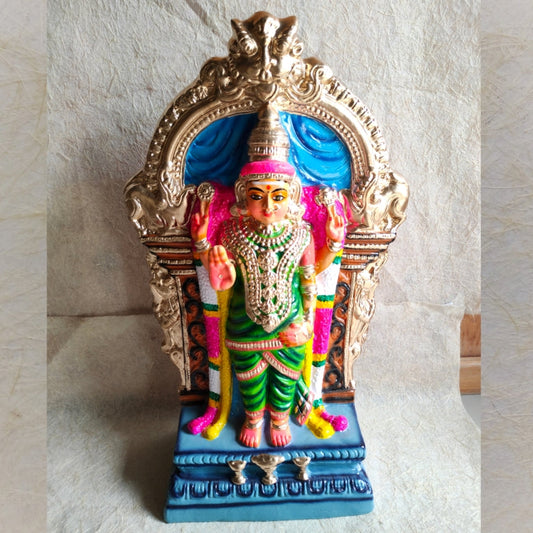 Handcrafted Navarathri Golu doll of Abayambigai Amman, adorned in a green saree with traditional jewelry, set under a golden arch with intricate detailing.