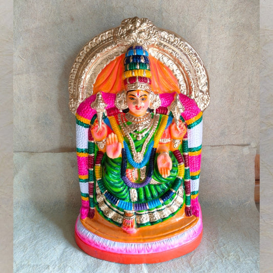 Handcrafted Navarathri Golu doll of Valaiyal Amman in green attire, seated under a golden arch, with colorful detailing and a traditional decorative backdrop.