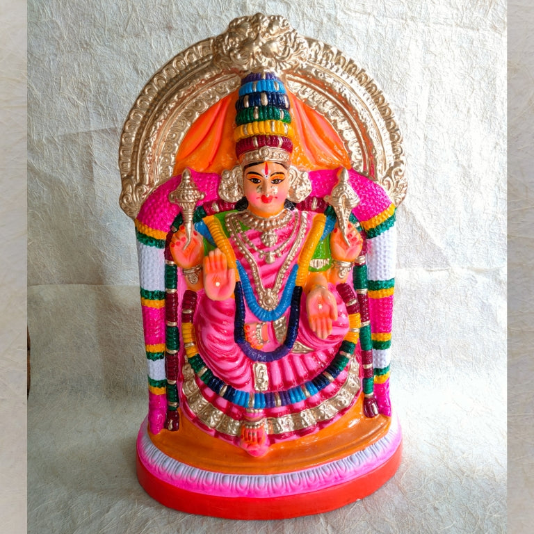 Hand-painted Navarathri Golu doll of Valaiyal Amman seated in a vibrant pink outfit with golden ornaments and a decorative arch background.