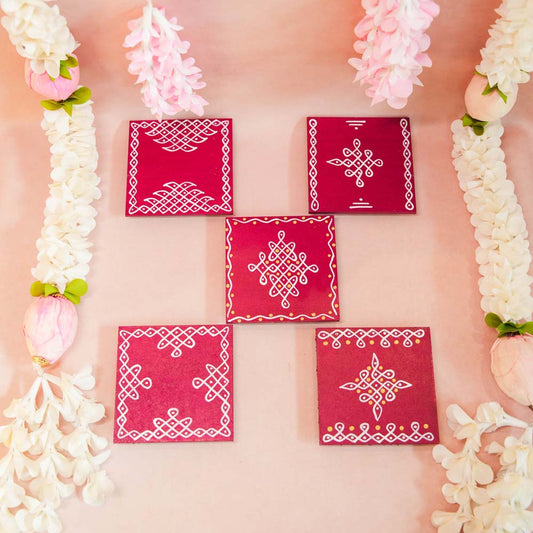 Handcrafted Square Kolam Manai in maroon with intricate white kolam patterns, displayed with floral garlands.