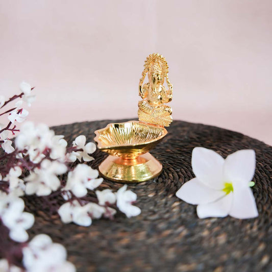 Gold Finish Ganesh Lamp with Intricate Design of Lord Ganesha Seated on a Pedestal.