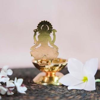 Gold Finish Lakshmi Lamp with Intricate Design of Goddess Lakshmi Seated on a Lotus.
