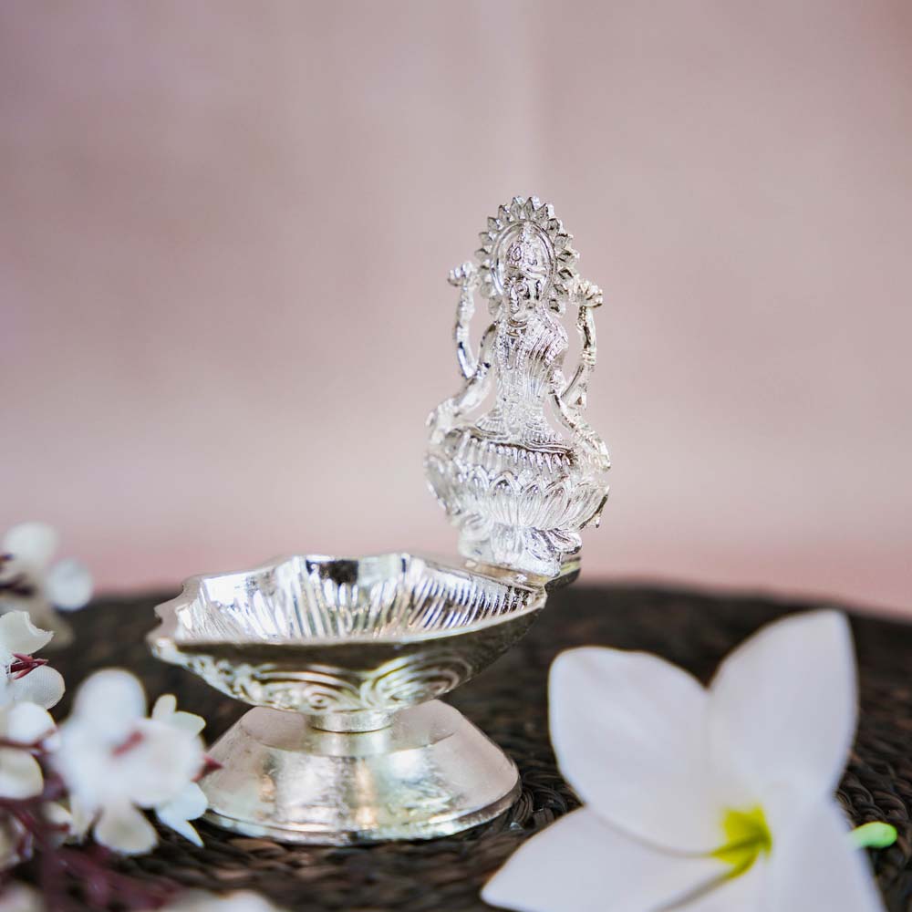 Silver Finish Lakshmi Lamp with Intricate Design of Goddess Lakshmi Seated on a Lotus.