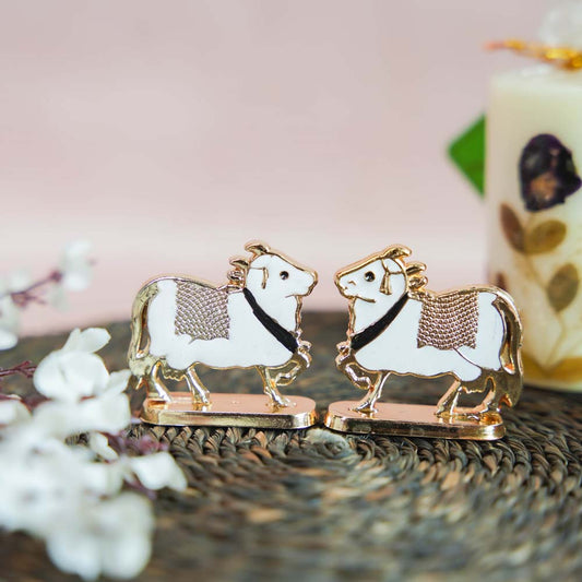 Miniature Cow Decor Set with Golden Finish and White Enamel Detailing.