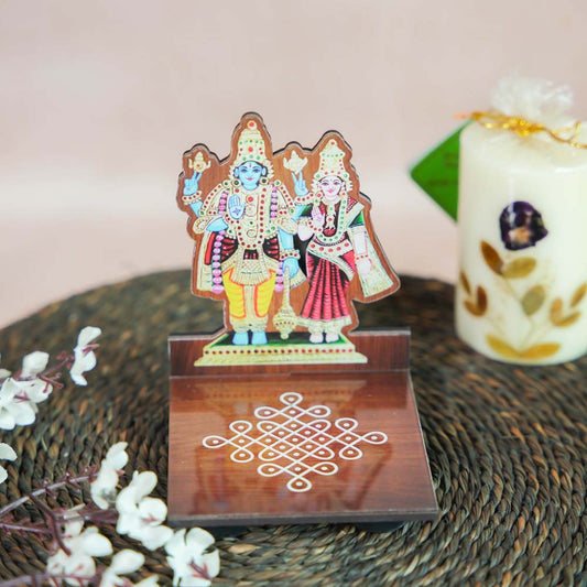 Shivan Parvati Diya Wall Stand featuring vibrant hand-painted artwork of Lord Shiva and Goddess Parvati with a kolam design base.