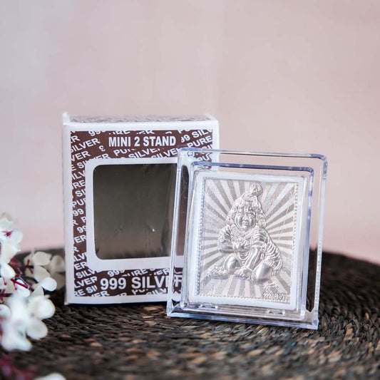 Silver Bal Krishna Frame in a Transparent Stand with Intricate Depiction of Baby Krishna.