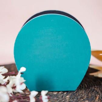 Hand-painted wooden penstand with a vibrant parrot design in peach and gold on a turquoise background.