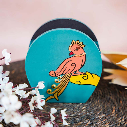 Hand-painted wooden penstand with a vibrant parrot design in peach and gold on a turquoise background.
