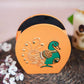 Hand-painted wooden penstand with a vibrant peacock design in green and gold on an orange background.