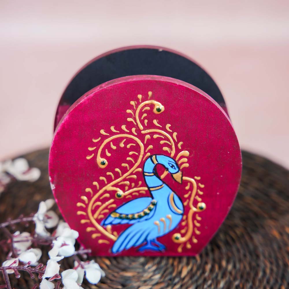Hand-painted wooden penstand featuring a vibrant blue Annam bird design with intricate gold accents, set against a deep red background.