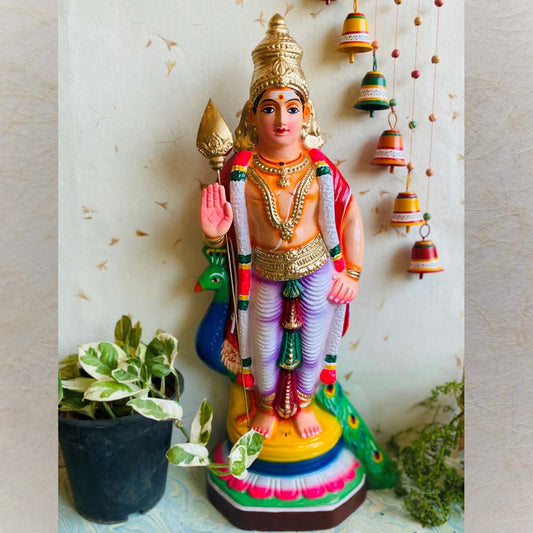 Handcrafted Navarathri Golu doll of Lord Murugan standing with Vel and accompanied by a peacock.