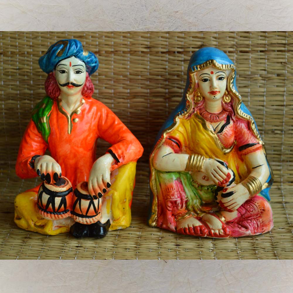 Set of 2 handcrafted Rajasthani musician figurines showcasing a male dholak player and a traditionally dressed female musician, vibrant and detailed.