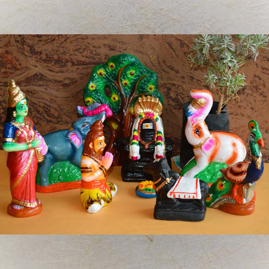Handcrafted Navaratri Thiruvanaikaval Golu doll set featuring Lord Shiva, Goddess Parvati, Nandi, elephants, and peacocks, painted in vibrant colors against a decorative background.