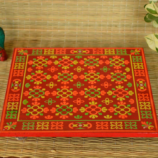 Wooden puja stool with colorful flower design and transparent acrylic feet.