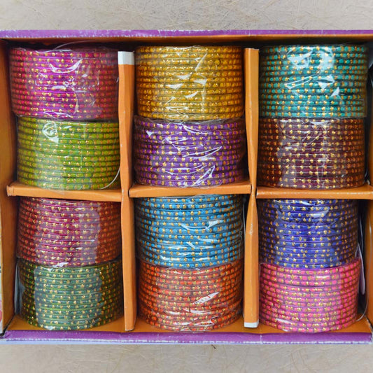 Box of colorful glass bangles with tiny gold dots, size 2.4, perfect for festive and traditional occasions.