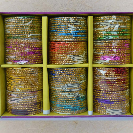 Box of 12 colorful glass bangles with black stripe patterns and gold line detailing, ideal for festive occasions, weddings, and traditional attire.