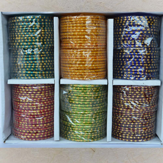 Box of colorful glass bangles with large gold single dots, size 2.6, ideal for festive and wedding wear.