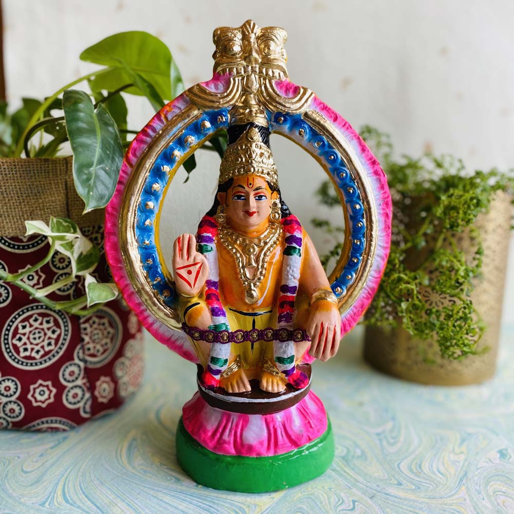 Handcrafted Navarathri Golu Doll of Lord Ayyappan in a seated pose with colorful arch and garland details.