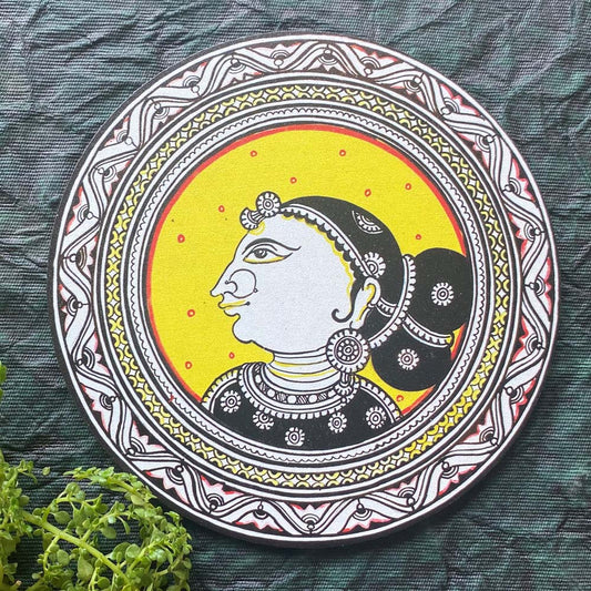 Decorative plate featuring the traditional profile of an Indian lady in yellow and black, adorned with intricate detailing and elegant patterns.