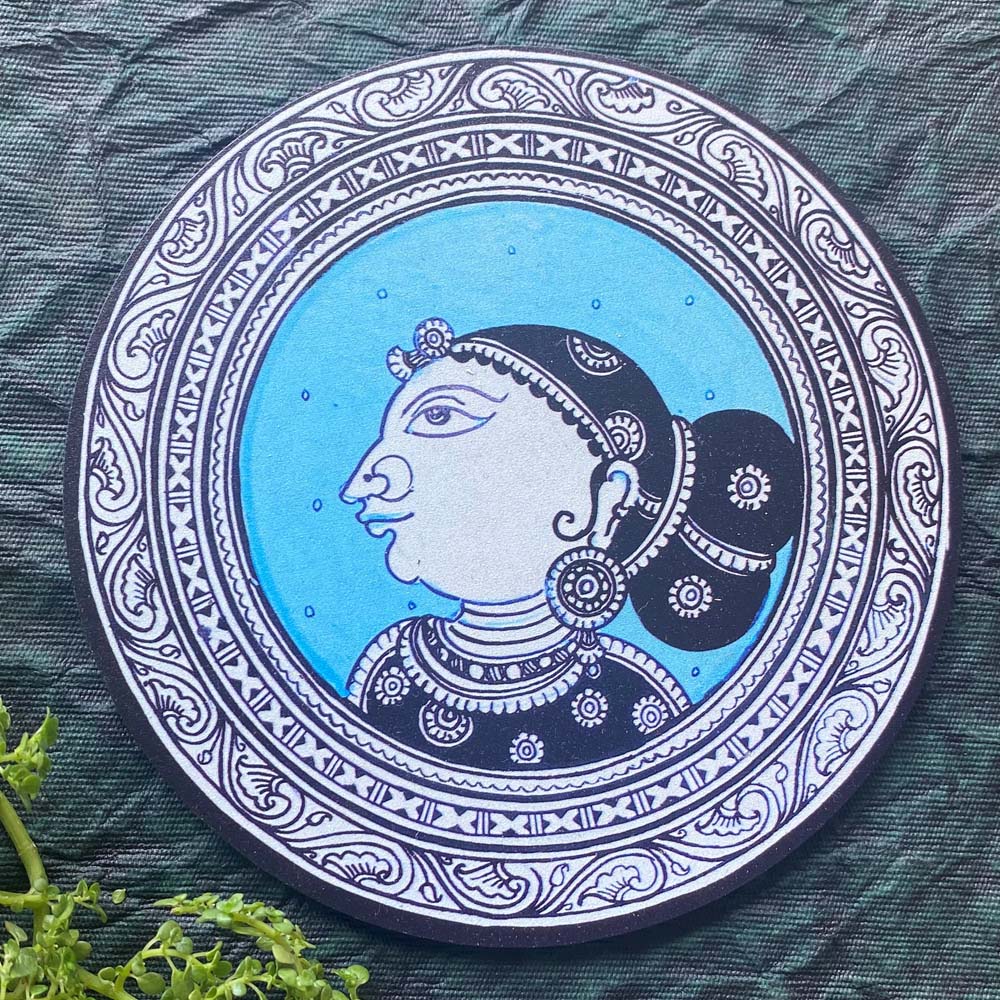 Decorative plate featuring the traditional profile of an Indian lady in blue and black, with intricate detailing and elegant patterns.