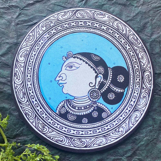 Decorative plate featuring the traditional profile of an Indian lady in blue and black, with intricate detailing and elegant patterns.