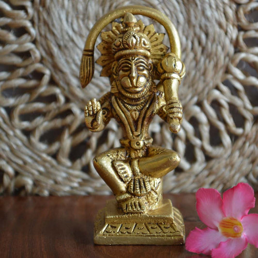 Eternal Hanuman Idol with an antique brass finish, seated and holding a mace, intricately detailed.