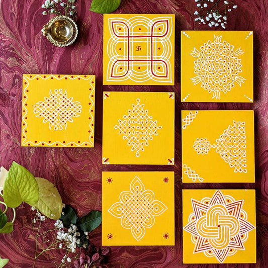 Hand-painted Kolam Manai wooden decor tile showcasing traditional white Kolam designs on an yellow background.