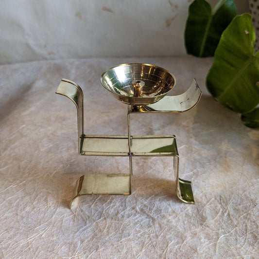 Handcrafted brass Swastik diya with a minimalist design, perfect for pooja rituals, festivals, and auspicious decor.