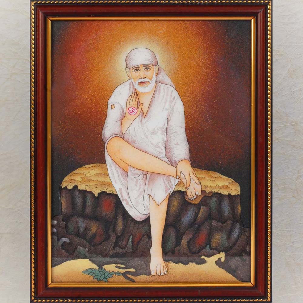 Framed painting of Shirdi Sai Baba seated on a stone bench, with a divine halo and raised hand in a blessing posture.
