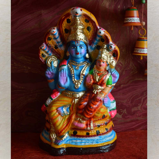 Handcrafted Navaratri Golu doll of Lord Narayana with Sridevi and Bhudevi, seated on Adisesha, adorned with vibrant colors and intricate details.