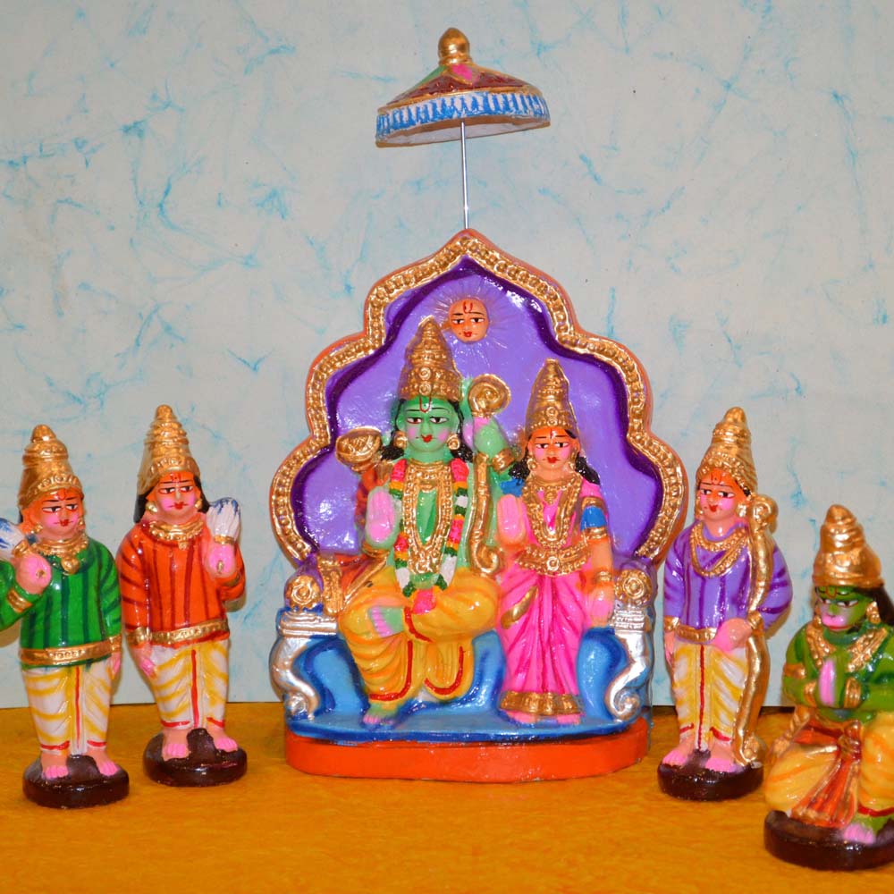 Handcrafted Ramar Pattabhishekam Golu dolls featuring Lord Rama, Sita, Lakshmana, Hanuman, and others, intricately painted and placed against a light blue background.