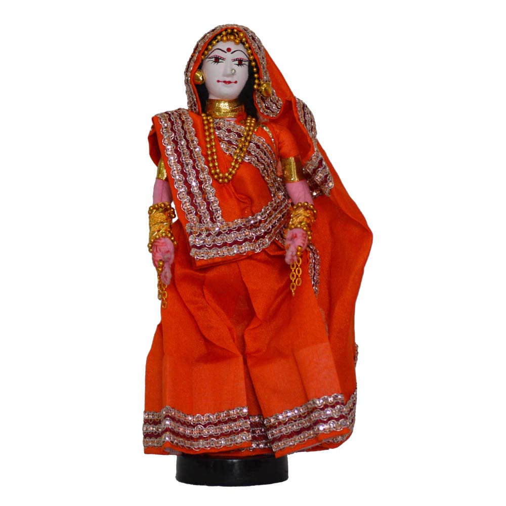 Traditional Navarathri costume doll of a lady dressed in an orange saree with golden embellishments.
